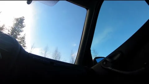 Timelapse of sunshine appearing after snowfall inside car cabin Stock Footage 265609012