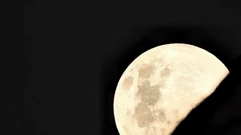 A timelapse of super closeup of full moon rising in a dark sky Stock Footage 326502444