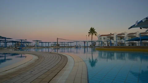 A Timelapse of swimming pool at a resort during sunset. Video stock 331201810
