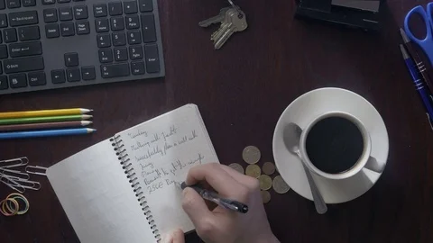 Timelapse of taking notes and typing on desktop. Video stock 75549593