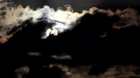 Timelapse telephoto clip of the sun appearing behind clouds Stock-Footage 45296341