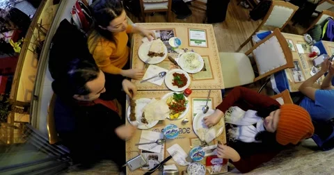 Timelapse of three people eating cag kebap in a turkish restaurant Stock Footage 58484207