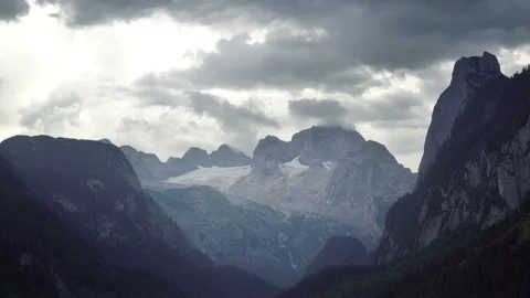 Timelapse of thunderstorm clouds gather at mountains peaks Stock Footage 121483927