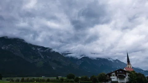Timelapse of thunderstorm clouds moving over mountains in austria Stock Footage 249807924