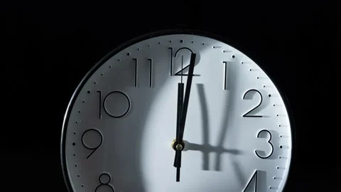 Timelapse of the time passing fast with the clock isolated on the empty black ba Stock Footage 239527152
