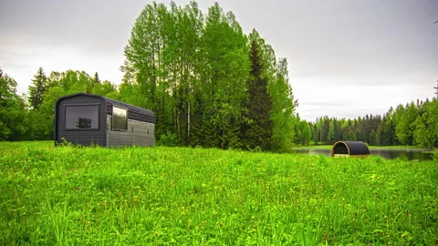 Timelapse of tiny modern homes located in open outdoors near a lake and a 스톡 동영상 227144281