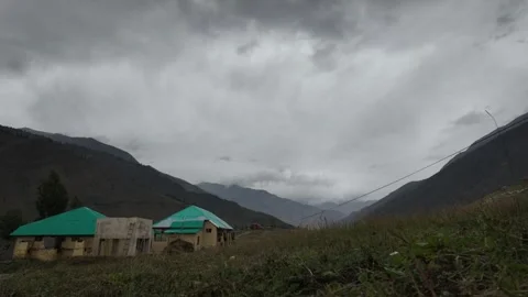 Timelapse Titans Dark Clouds Sweep Across the White Sky, Framing Towering Stock Footage 286416408
