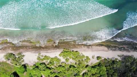 Timelapse top down aerial view of wild beach on sunny day, clouds moving Stock Footage 155034026