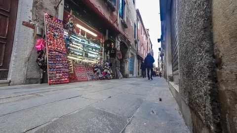 Timelapse of tourists in a narrow passage between old brick buildings in Venice Stock Footage 89149610