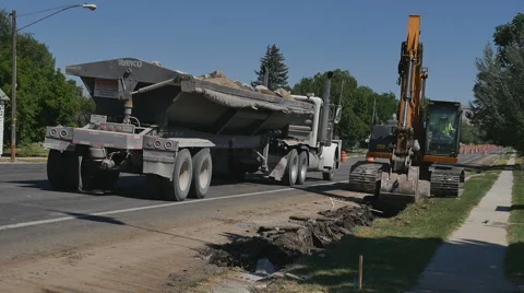 Timelapse-Track hoe digs up old curb and gutter for highway restorat Stock Footage 65425891