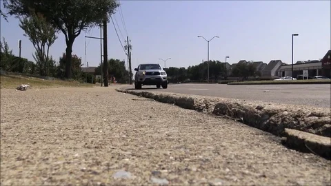 Timelapse Traffic drives by broken sidewalk 8x speed Stock Footage 80003605