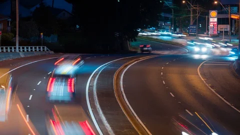 Timelapse of traffic at dusk down Ryde Road, seen from bridge at Pymble Stock Footage 128997040