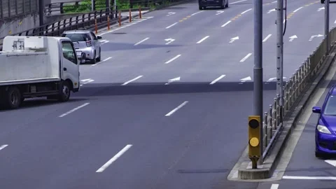 A timelapse of traffic jam at the city crossing in Tokyo telephoto shot panning Stock Footage 314241775