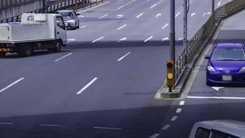A timelapse of traffic jam at the city crossing in Tokyo telephoto shot tilt Stock Footage 314241955