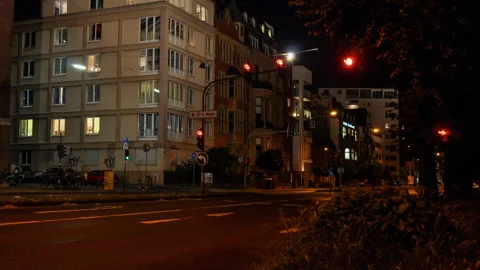 Timelapse of traffic lights and driving cars at night in germany Stock Footage 250082096