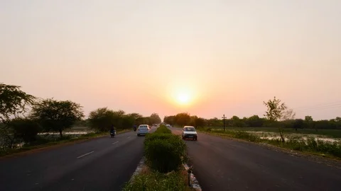 Timelapse of Traffic moving opposite sides on a Two Way Road at Sunset Stock Footage 113479870