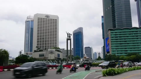 Timelapse of traffic passing by Selamat Datang statue at Bundaran Hi, Jakarta Stock Footage 237174838