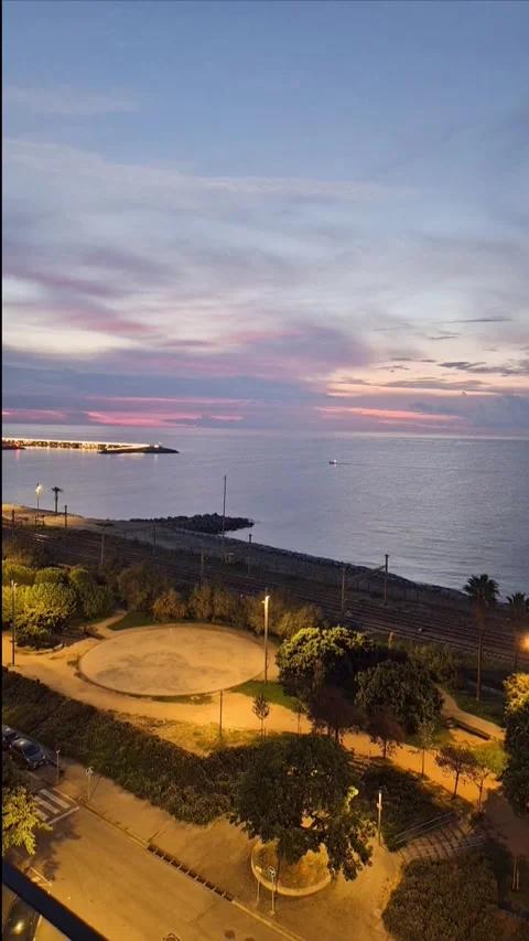 Timelapse of a train passing along coastal railway at sunset with fast motion li Stock Footage 332985964
