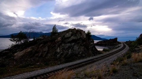 Timelapse of train tracks going along Alaskan Fjord near Seward highway Stock Footage 113490639