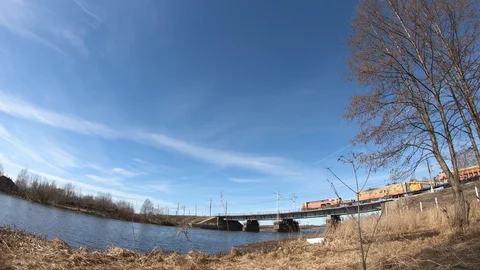 Timelapse train traffic on the railway bridge over the river. Stock Footage 106445072