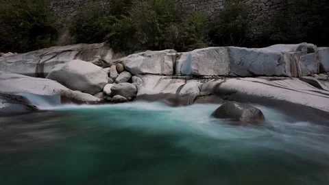 Timelapse of turquoise mountain river pool between dark rocks Stock Footage 346183866