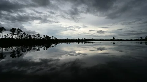 Timelapse of twilight cloudscape over Pine Glades Lake in Everglades 4K. Stock Footage 219374127