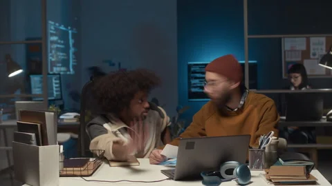 Timelapse of Two IT Guys Sitting at Workplace and Having Discussion Stock Footage 279621881