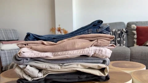 Timelapse of undoing a stack of folded clothes Stock Footage 331939429