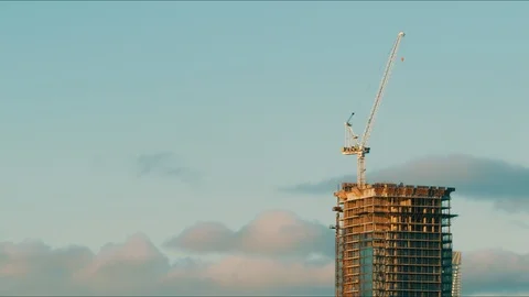 Timelapse of Unfinished Skyscraper During Sunset with Clouds Stock Footage 101408177