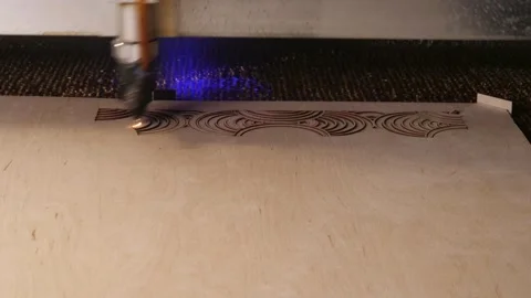 Timelapse use of laser in industry. laser is cutting a pattern on plywood sheet Stock Footage 266822866