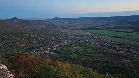 Timelapse of valley with settlement showing how it is getting dark Video stock 255482925