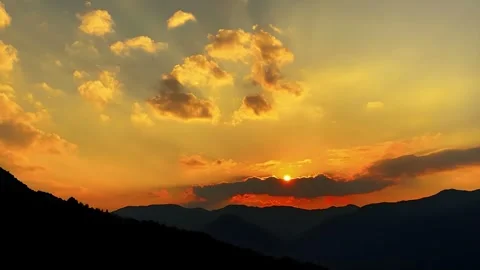 Timelapse of Vibrant Sunset with Golden Clouds Over Mountains, Yunnan Stock-Footage 336060704