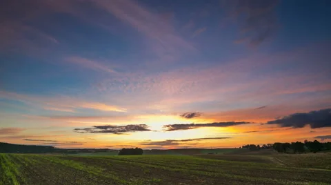 Timelapse of vibrant sunset over field. 4k timelapse Stock Footage 58893974
