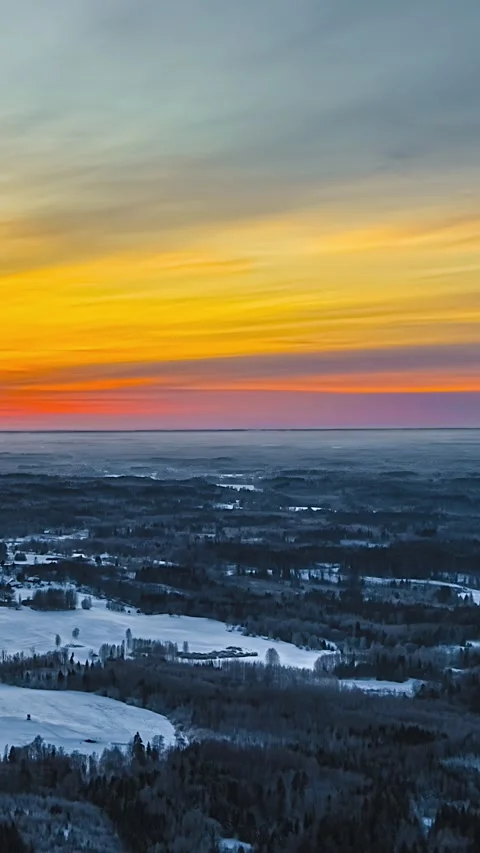 Timelapse of Vibrant Winter Sunrise Over Snowy Rural Landscape and Forests Stock Footage 341839322