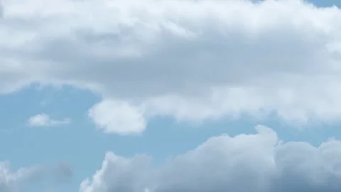 A timelapse video capturing the swift movement of white clouds across a stark Stock Footage 334011733