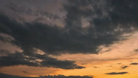 Timelapse Video of Dark Storm Clouds Gathering Over Golden Sunset Sky Stock Footage 345849954