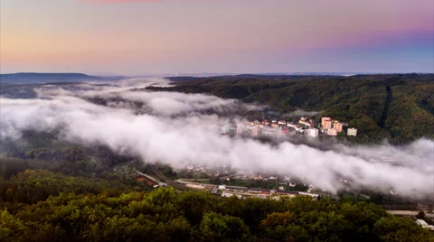 Timelapse video of a dawn over a forested city in a valley Stock Footage 35879391