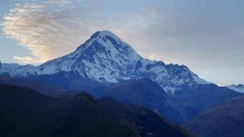 Timelapse video of flying clouds over a snowy mountain peak Stock Footage 224851849