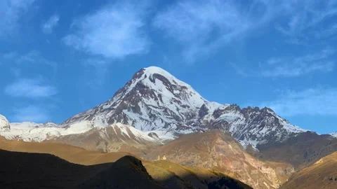 Timelapse video of flying clouds over a snowy mountain peak Stock Footage 224855468