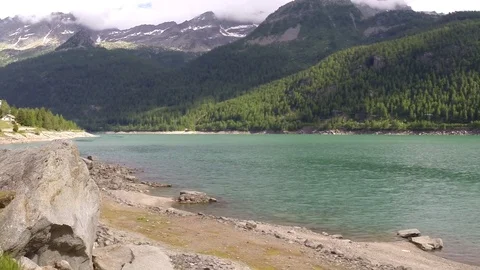 Timelapse video mountain lake in the Italian Alps. fast flying clouds. Stock Footage