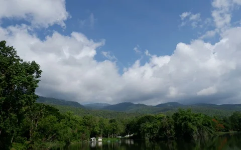 Timelapse video of the movement of the clouds over the mountains and lake. Stock Footage 129587266