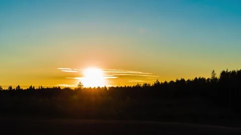 Timelapse video of setting sun over the forest Stock Footage 153873421