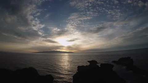 Timelapse video of sunset on the seashore with a view of another island Stock Footage 196136124