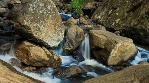 Timelapse video of water passing through large rocks. Stock Footage 61785643