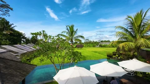 Timelapse view from 2nd floor of a cottage with pool and paddy fields Stock Footage 237852505