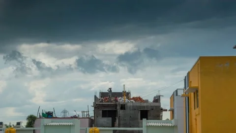 Timelapse view from below of some builders working on the new frame house roof. Stock Footage 171257132
