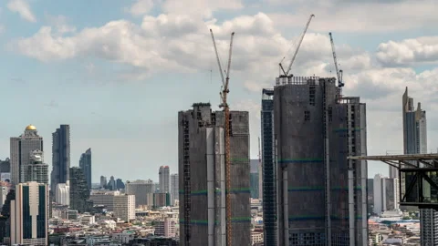 Timelapse view of big construction cranes working on top of high-rise buildings Stock Footage 278057771
