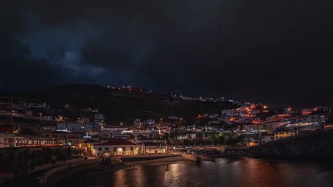 Timelapse view of Câmara de Lobos harbor with the city's evening lights Stock Footage 301718551