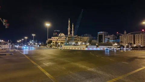 A timelapse view of cars moving through a traffic junction in Sharjah, United 動画素材 332047408