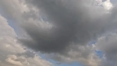 Timelapse view of dark cloudy sky moving to cover the blue sky during the day Stock Footage 319967414